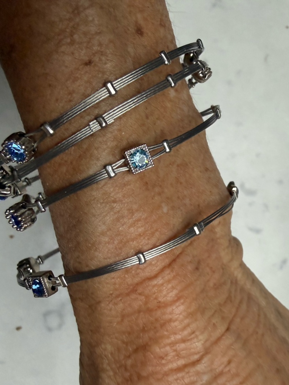 Sterling-Tone Multiwire Bracelet with Light Blue Crystal Accent